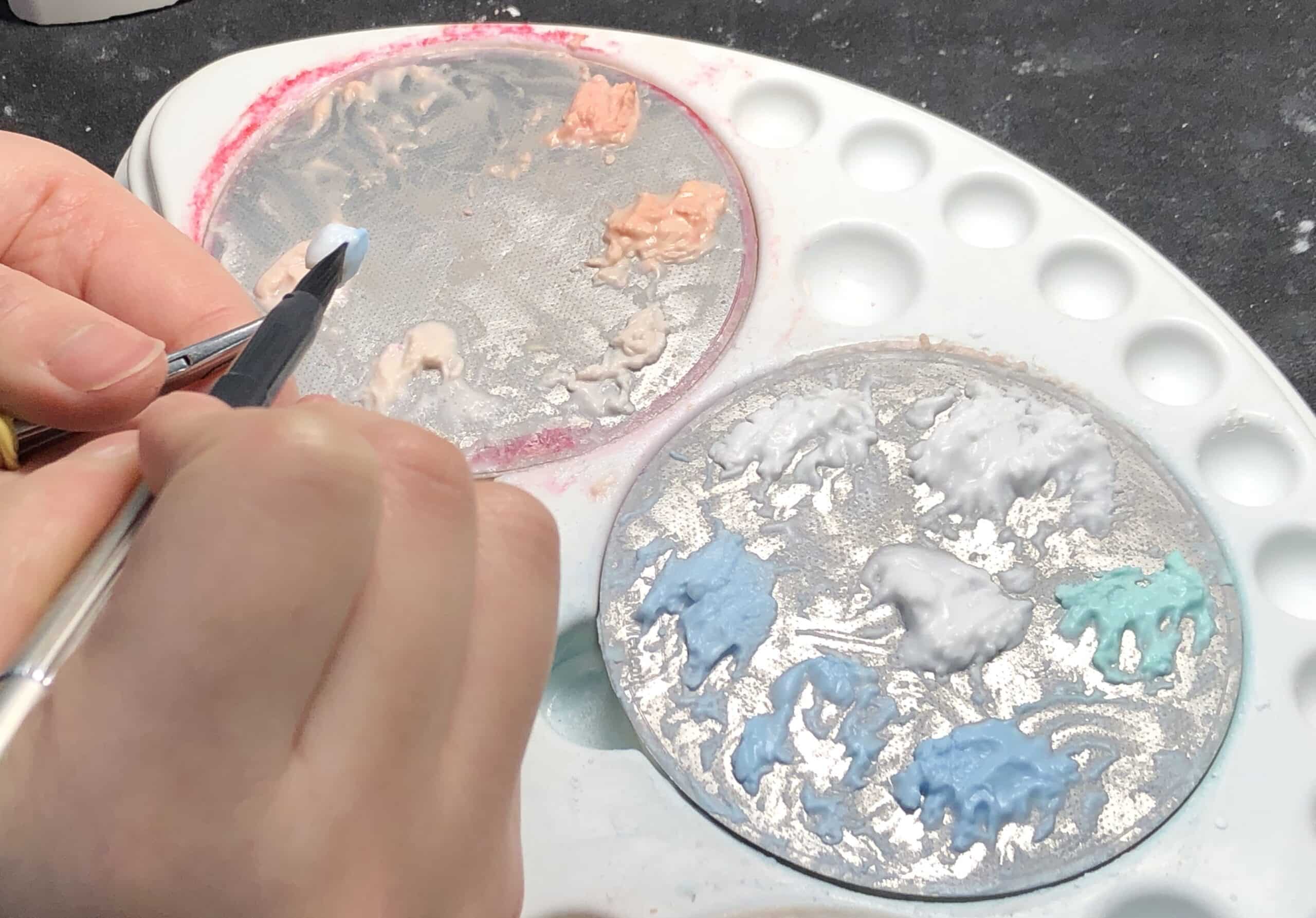 Dental laboratory ceramist hand layering ceramic crown for high-volume clinic restorations